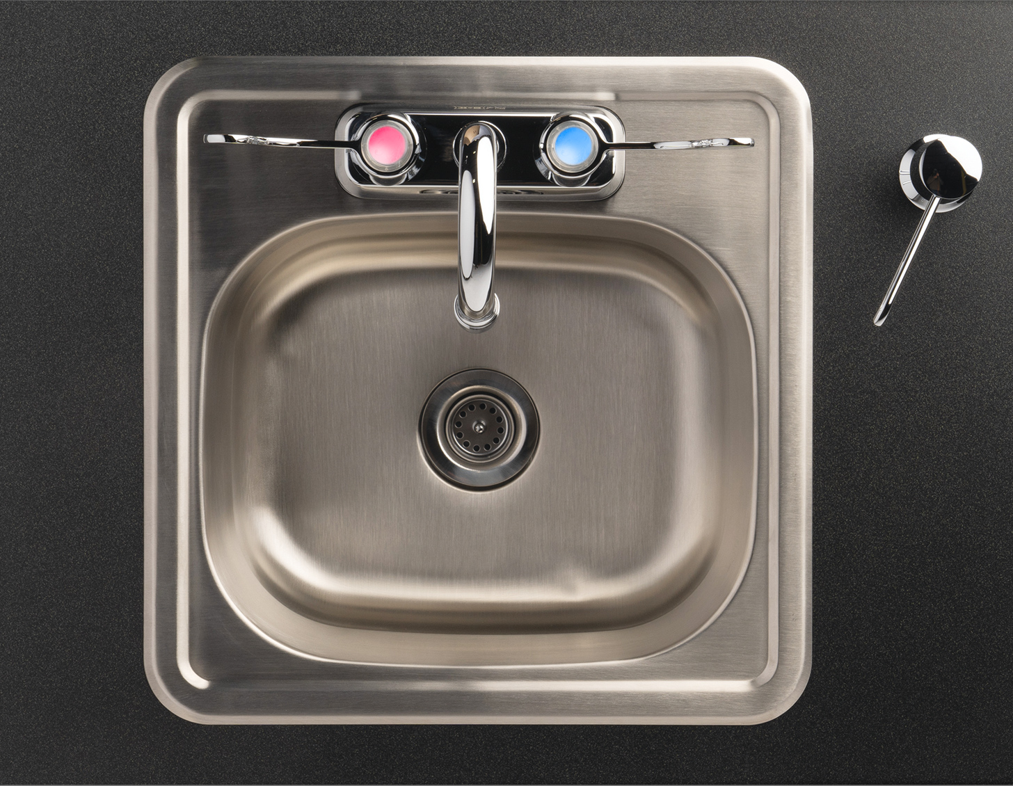 Laminate countertop and single stainless steel sink basin with built-in soap dispenser